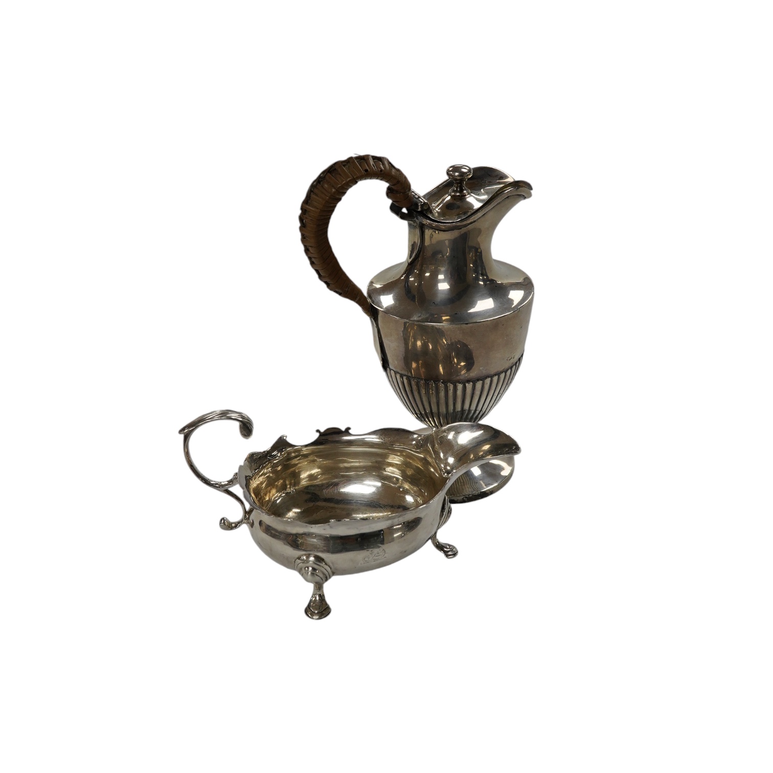 A George II small silver sauceboat, Gwillim & Castle, London, 1744, length 13.6cm, together with a George III silver hot water jug, London, 1791, gross 9.6oz. Condition - poor